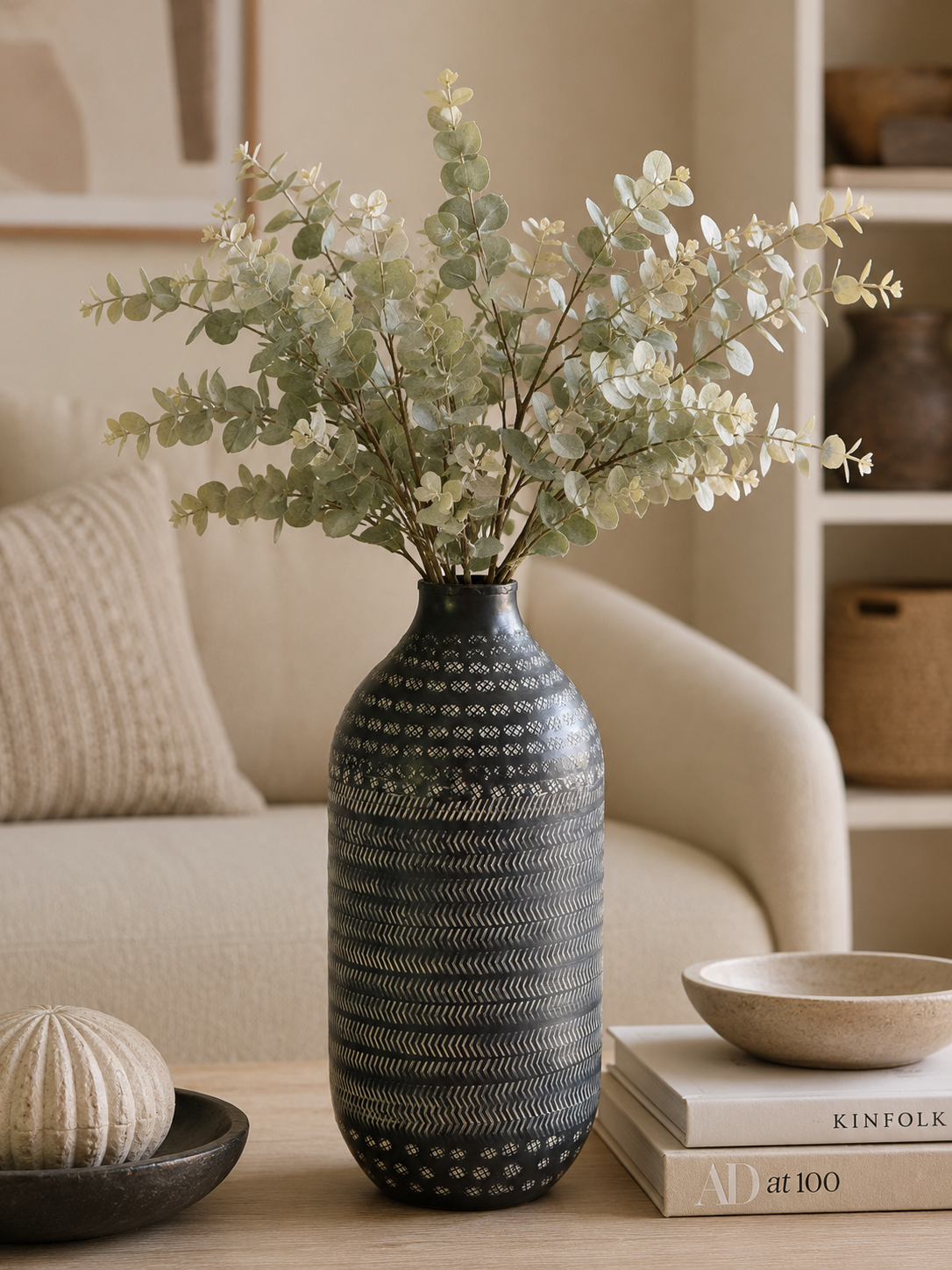 Rustic metal vase with greens